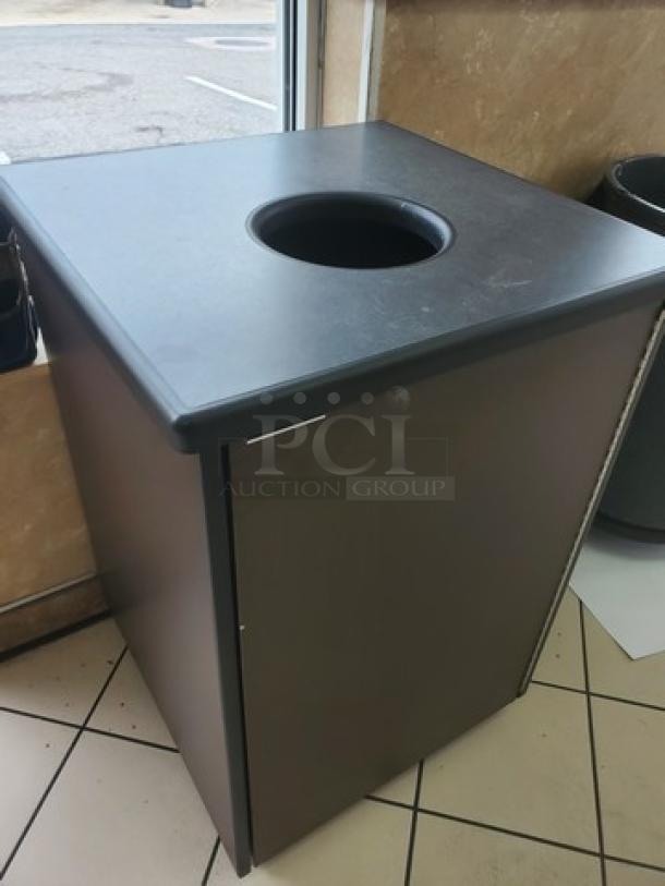 Lot of 2 wooden waste receptacles with circular openings, dark finish, suitable for commercial use, minor surface wear.