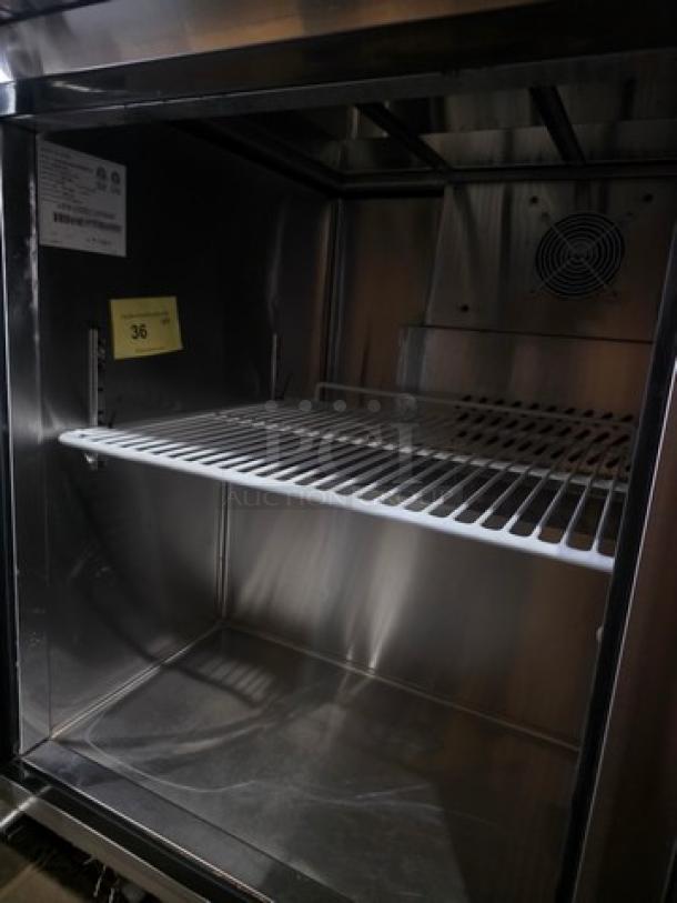 Migali 48″ sandwich prep table, model C-SP48-12-HC, features 12 pans. Stainless steel interior with shelving.