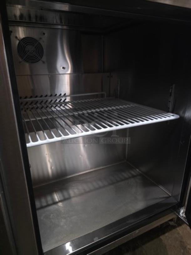 Migali C-SP48-12-HC sandwich prep table interior, features a stainless steel interior with a wire shelf, 48-inch model.