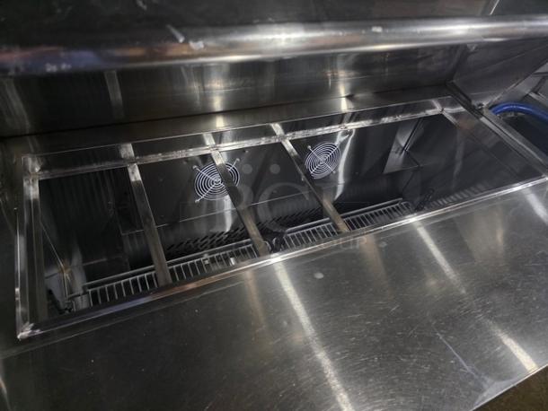 Migali C-SP48-12-HC sandwich prep table, stainless steel, 48", 12-pan capacity, excellent condition, refrigeration fans visible.