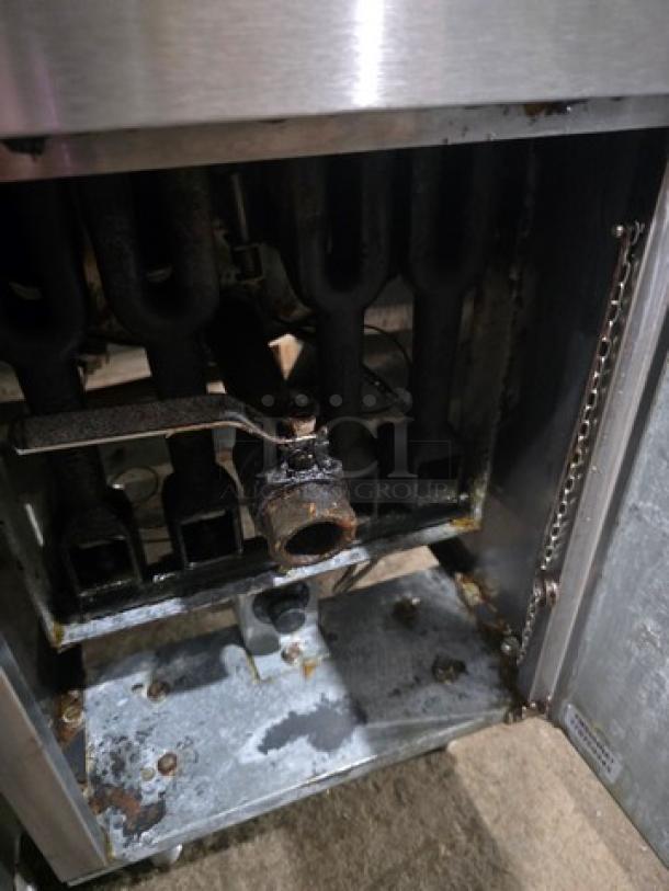 Cecilware Pro FMS504 natural gas floor fryer showing internal gas connections and burner section, in used condition.