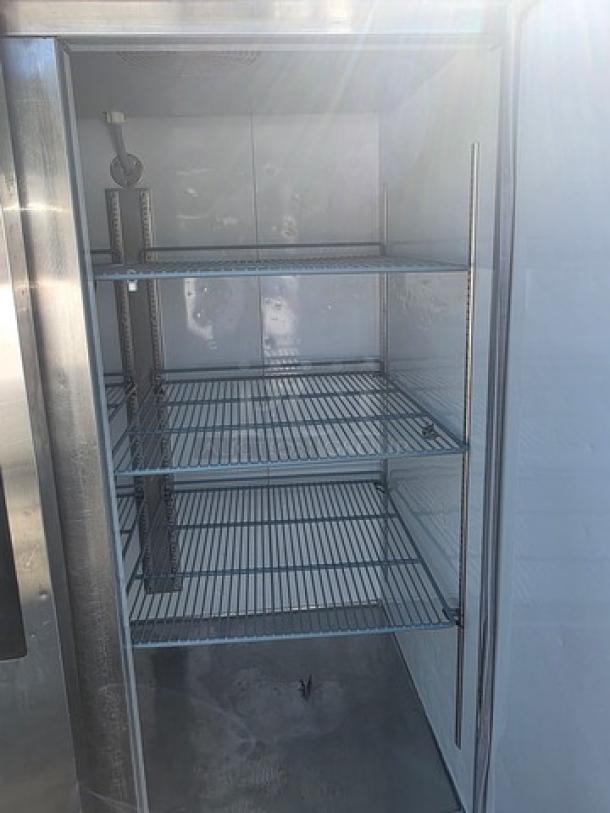 Avantco A-49F-HC 54" solid door reach-in freezer with three adjustable shelves, stainless steel interior, and external temperature gauge.