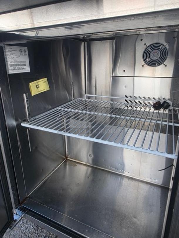 Migali C-SP72-30BT-HC prep table interior with metal shelf, fan, and label. Clean stainless steel finish.