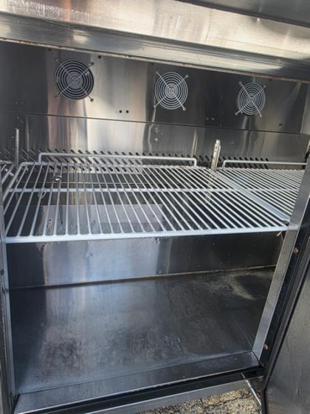 Migali C-SP72-30BT-HC sandwich prep table interior, stainless steel shelves, dual fans, overhead shelf included.