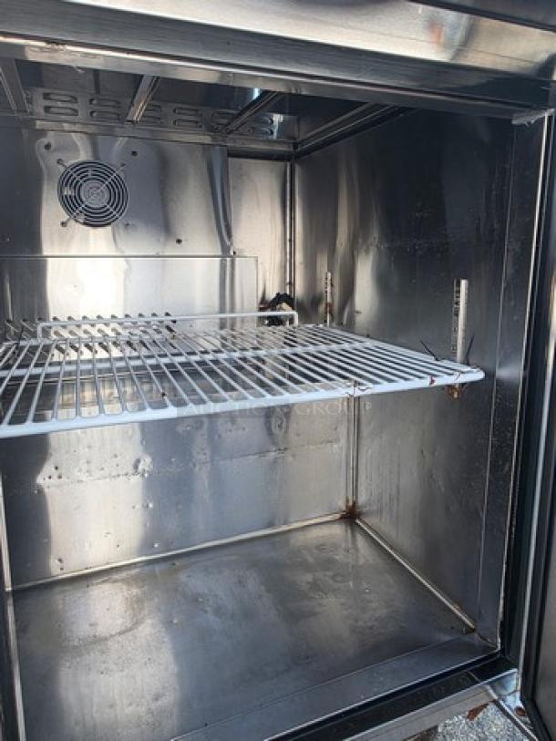 Migali C-SP72-30BT-HC prep table interior, stainless steel, wire shelf, visible fan, clean condition.