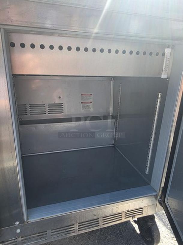 Beverage-Air SPE48HC-18M sandwich prep table, mega-top, stainless steel, empty interior, adjustable shelves, visible cooling vents.