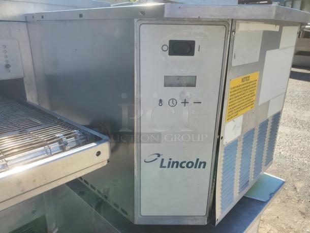 Lincoln Impinger double stack pizza conveyor oven, model 1600-015-AR, 110,000 BTU, natural gas, visible control panel and safety notice.