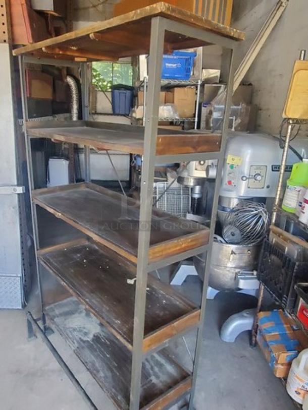 Industrial-style 5 tier shelf with metal frame and wooden shelves. Visible wear and patina, suitable for storage and display.