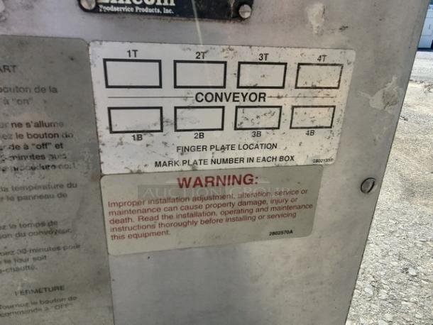 Lincoln Impinger 1450 pizza conveyor oven. 120 VAC, 1 PH, natural gas, 70,000-120,000 BTU. Warning plate visible.
