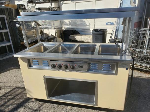 Colorpoint 5E4-CPA-EB electric steam table with four wells, control knobs, and metal frame. Good condition; 208V, 1PH, 60Hz.