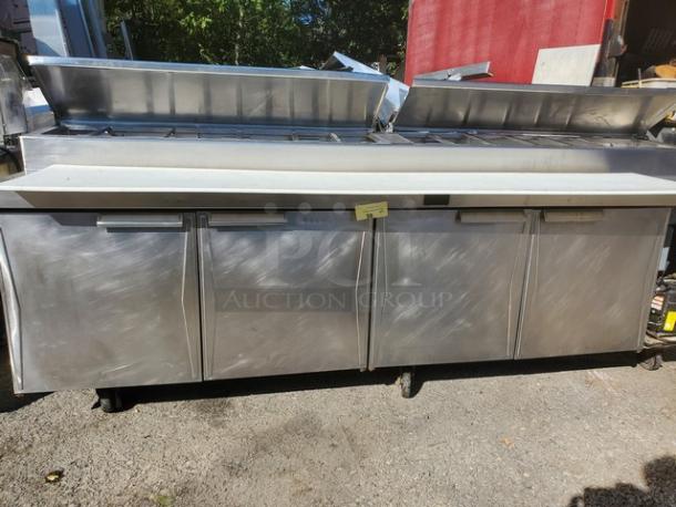 Randell Sandwich Prep Table, stainless steel, four-door, top compartments open, used condition, ideal for commercial kitchens.