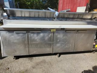 Randell Sandwich Prep Table, stainless steel, four-door, top compartments open, used condition, ideal for commercial kitchens.