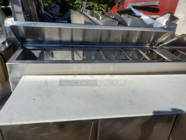 Randell Sandwich Prep Table, stainless steel, multiple compartments, cutting board surface, good condition, ideal for commercial use.