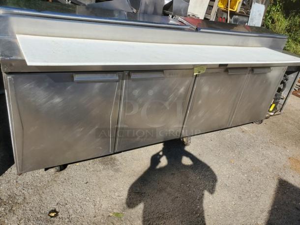 Randell sandwich prep table, stainless steel, three compartments, cutting board top, on wheels, good condition.