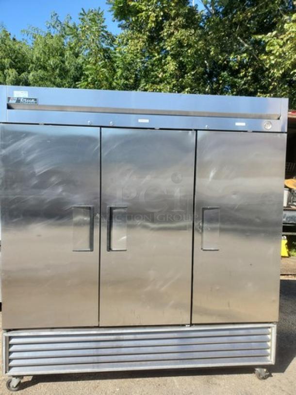 True T-72F T-Series 3-section solid door reach-in freezer, stainless steel, on casters, good condition, branded label visible.