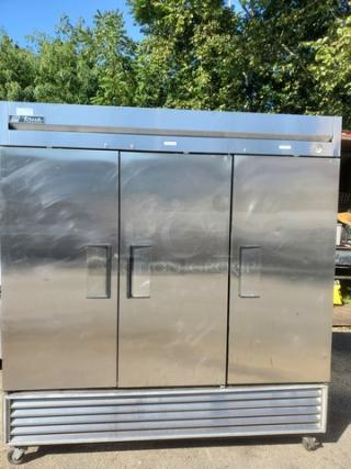True T-72F T-Series 3-section solid door reach-in freezer, stainless steel, on casters, good condition, branded label visible.