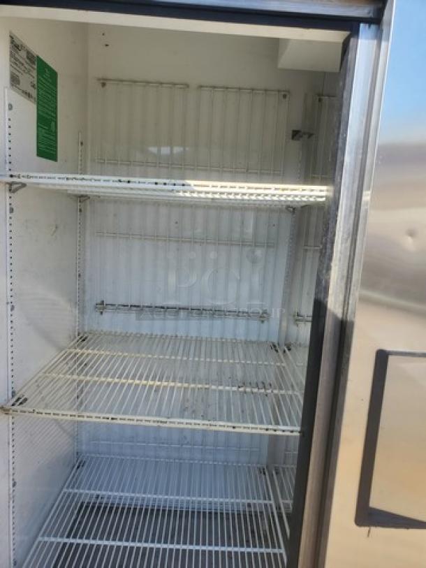 True T-72F T-Series 3-Section Solid Door Reach-In Freezer. Features wire shelves, visible interior wear.