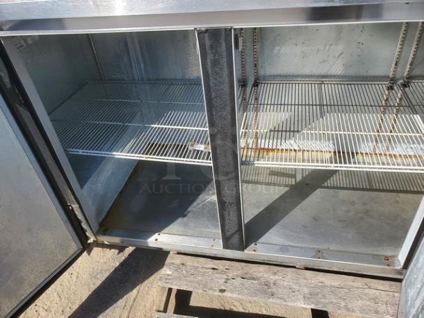 Beverage Air BB78 black three solid door back bar refrigerator, 78", interior racks visible, moderate wear.