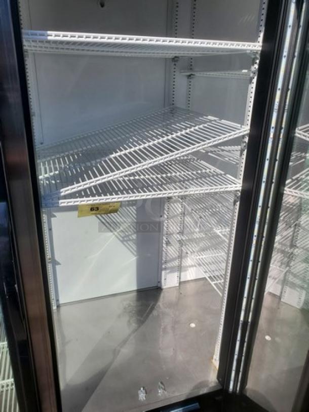 True GDM-72-HC-TSL01 78" glass door merchandiser, three sections, clean shelves, 115V, 60 Hz, 1PH, model label visible.