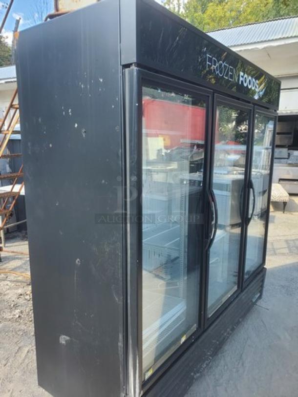 True GDM-72F-HC-TSL01 78" 3-section glass-door freezer, used condition, black exterior, "Frozen Foods" label.