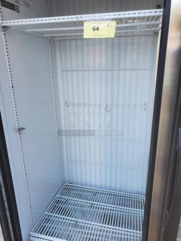 True GDM-72F-HC-TSL01 78" 3-section glass-door merchandiser freezer, empty interior, white with adjustable shelves, tag showing "64".