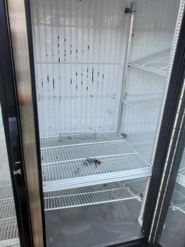 True GDM-72F-HC-TSL01 78" 3-section glass-door merchandiser freezer with spacious interior, visible shelving, good condition.