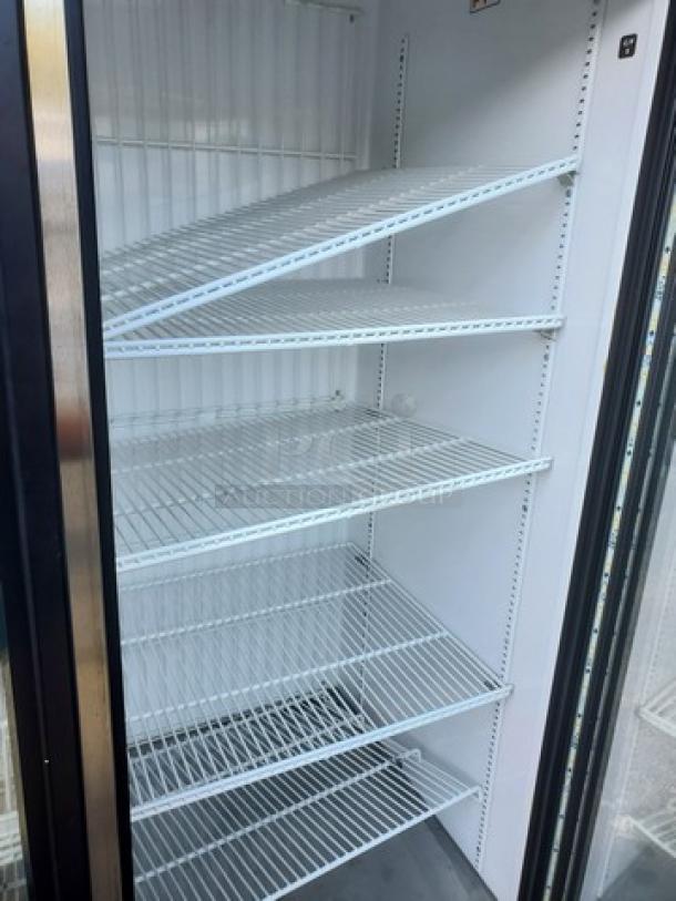 True GDM-72F-HC-TSL01 78" 3-section glass-door merchandiser freezer, five white shelves, minimal wear, clean interior.
