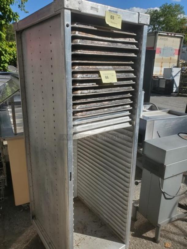 Mobile sheet pan rack, metal construction, holds multiple pans, visible wear. Sheet pans not included.