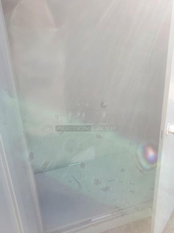 Metal cabinet with visible dents and scratches, open door, reflective surface, showing interior shelf. Used condition.
