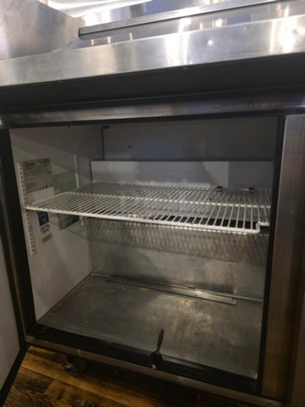 True QA-60-24M-B 60" Refrigerated Prep Table, open with shelving visible, stainless steel, 115V, 60 Hz, 1 PH, used condition.