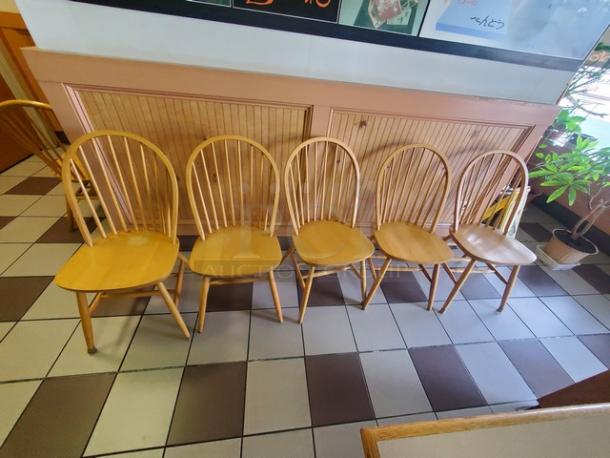 Lot of 5 wooden dining chairs with spindle backs. Light finish, classic design, good condition. Ideal for casual dining.