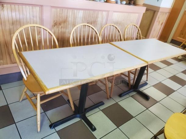 Two rectangular dining tables with light wood edges and black metal bases, in good condition.