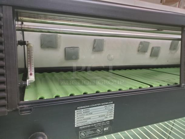 Hoshizaki HNC-120AA-R countertop refrigerated sushi display case, featuring green interior, visible thermostat, and brand label.