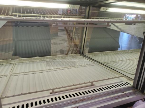 Federal Industries 5942SC-2, 59" flat glass refrigerated bakery display case, excellent condition. Spacious interior with shelves.