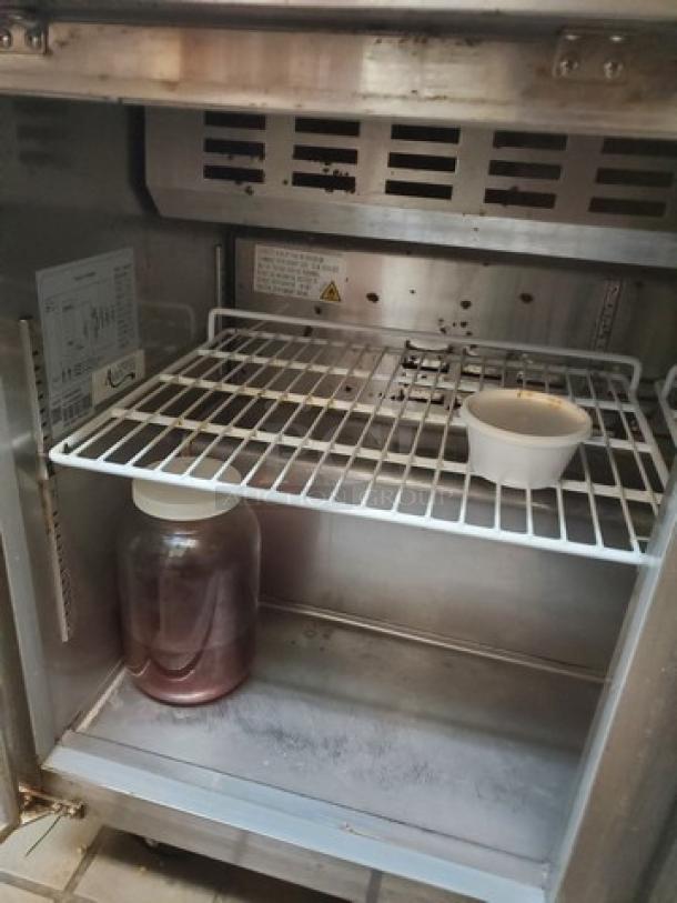 Avantco 178SSPT48HC 46" 2-door stainless steel refrigerated sandwich prep table. Inner shelves and label visible. Contents not included.