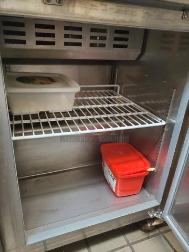 Avantco 178SSPT48HC 46" two-door stainless steel refrigerated sandwich prep table, used, with empty interior.
