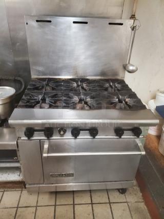 American Range 6 Burner Natural Gas Range, stainless steel, visible wear, heavy-duty commercial kitchen use.