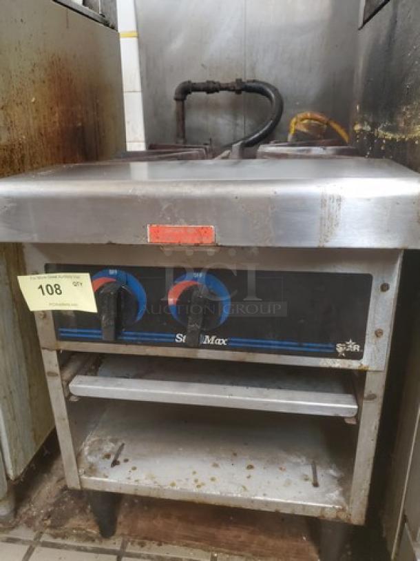 Star-Max countertop gas stock pot range with dual burners, stainless steel, visible signs of use, model marked "Star."