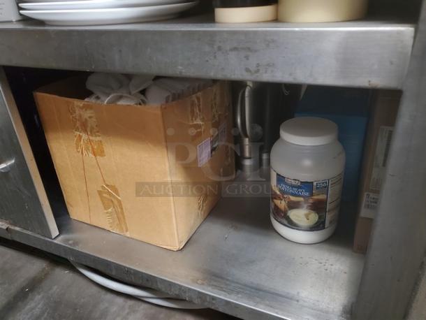 Stainless Steel Work Counter, durable surface, sturdy build, minor wear visible; contents not included.