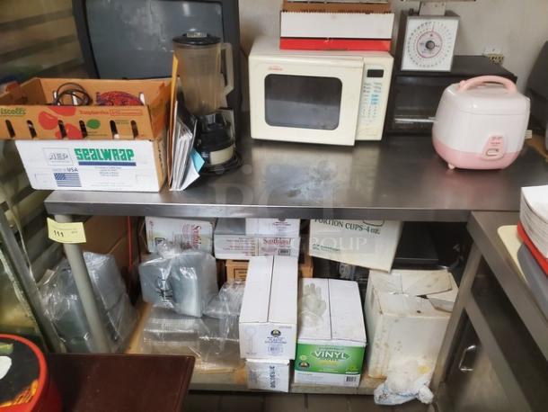 Stainless steel work table, durable, used condition, suitable for commercial kitchens. Contents not included.