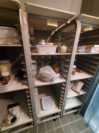 Metal sheet pan rack with multiple tiers, empty of contents, numbered labels attached, in good condition.