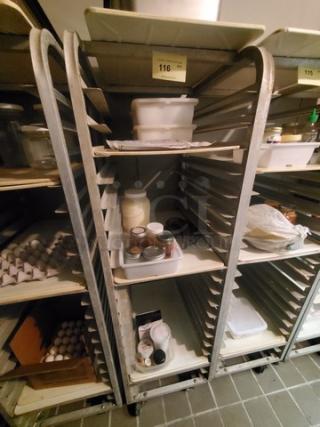 Metal sheet pan rack with wheelbase, multiple slots for pans, used condition. Contents not included.