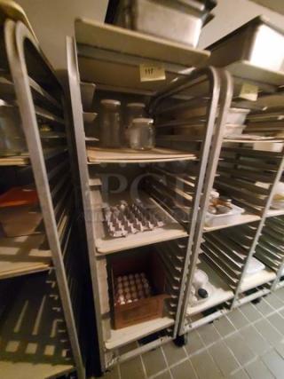 Metal sheet pan rack with multiple shelves, in used condition, no contents included. Upper label marked "117."