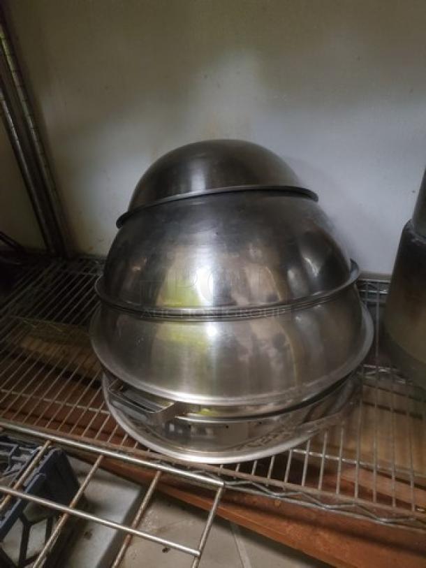 Lot of 7 stainless steel bowls, varying sizes, stacked on a wire shelf. Used condition. Ideal for mixing or serving.