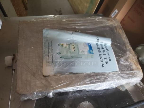 Kolice ICM 200E Ice Cream Machine, wrapped in plastic, includes operation manual on top, appears unused.