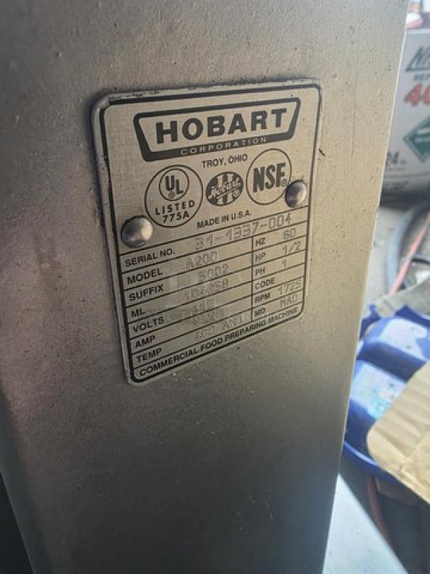 Hobart A200 20 Qt Commercial Dough Mixer, model label shown. Includes attachments. 3rd gear slightly grinds.