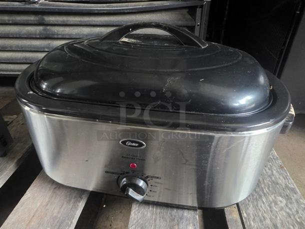 Oster 22 Qt Roaster Oven, stainless steel finish, adjustable temperature knob, light wear. Model label visible.
