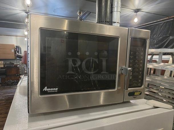 Amana Menumaster Commercial Microwave Oven RFS10SW2, stainless steel, digital keypad, visible brand logo, excellent condition.