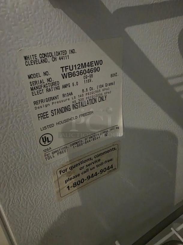 Tappan Upright Freezer, Model TFU12M4EW0, with manufacturer's label detailing serial number and specifications.