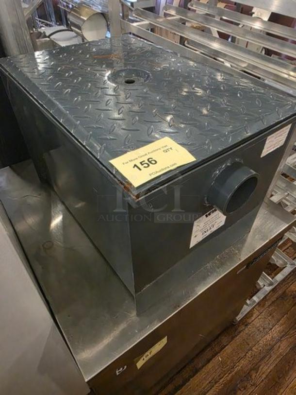 Watts WD-20 Grease Interceptor, 40 lb. capacity, diamond plate cover, visible labels, new condition.